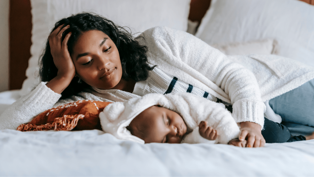 mother watching baby sleep